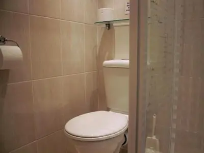 a bathroom with a white toilet and a shower at Seagull Hotel in Blackpool