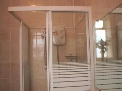 a shower with a glass door in a bathroom at Seagull Hotel in Blackpool