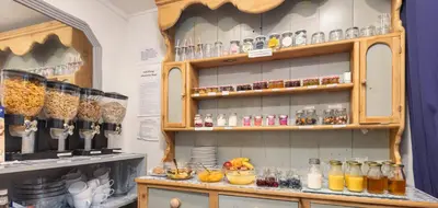 a kitchen with a shelf filled with lots of glass items at The Fairmile in Lytham St Annes
