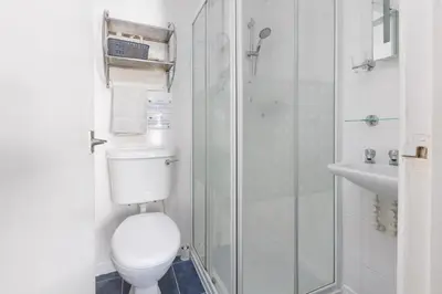 a bathroom with a toilet and a glass shower at The Fairmile in Lytham St Annes
