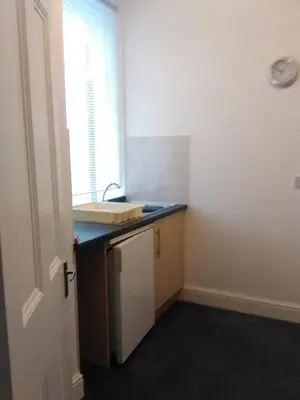 a small kitchen with a sink and a window at Delamere holiday flat in Blackpool
