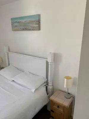 a bedroom with a bed and a table with a lamp at Delamere holiday flat in Blackpool