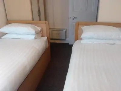 two beds sitting next to each other in a room at Delamere holiday flat in Blackpool