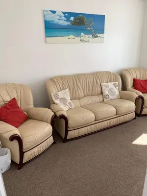 a living room with a couch and two chairs at Delamere holiday flat in Blackpool