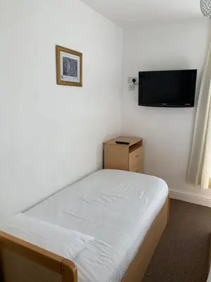a bedroom with a bed and a flat screen tv at Delamere holiday flat in Blackpool