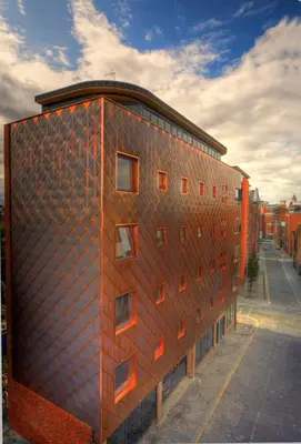 a brick building with windows on the side of it at The Print Works Apartments in Liverpool