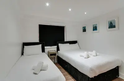 two beds sitting next to each other in a room at The Print Works Apartments in Liverpool