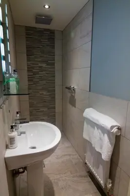 a bathroom with a sink and a shower at The Red Pump Inn in Clitheroe