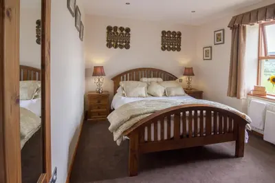 a bedroom with a large bed and a window at The Red Pump Inn in Clitheroe