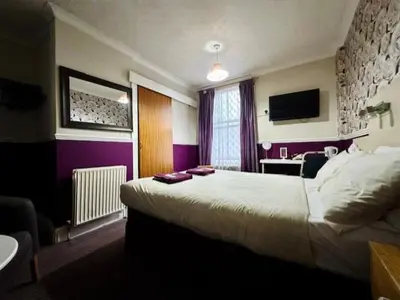 a hotel room with a bed and a desk at The Avon in Blackpool