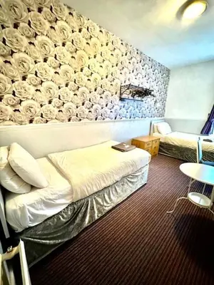 a hotel room with a bed and a couch at The Avon in Blackpool