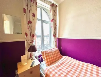 a small bedroom with a bed and a window at The Avon in Blackpool
