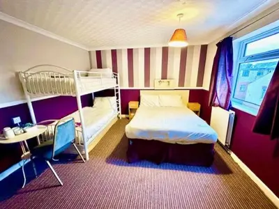 a bedroom with two bunk beds and a desk at The Avon in Blackpool