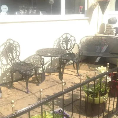 a group of chairs and tables in a patio at The Dragonfly in Blackpool