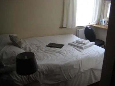 a bedroom with a bed with a book on it at The Dragonfly in Blackpool