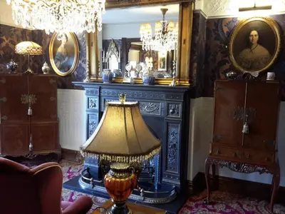 a living room with a lamp and a mirror at The Lonsdale in Blackpool