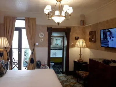 a bedroom with a bed and a chandelier and a living room at The Lonsdale in Blackpool