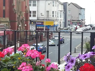 a view of a city street with pink flowers at The Lonsdale in Blackpool