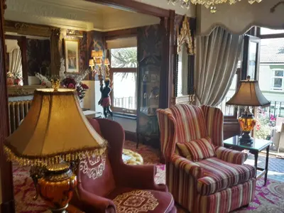 a living room with two chairs and a lamp at The Lonsdale in Blackpool