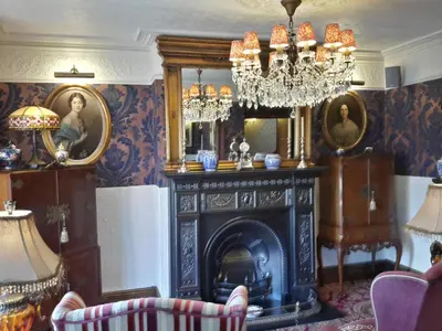 a living room with a fireplace and a chandelier at The Lonsdale in Blackpool