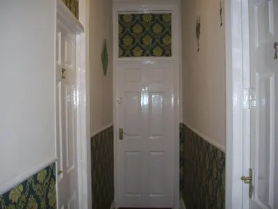 a hallway with a white door in a room at Royal Hotel in Blackpool