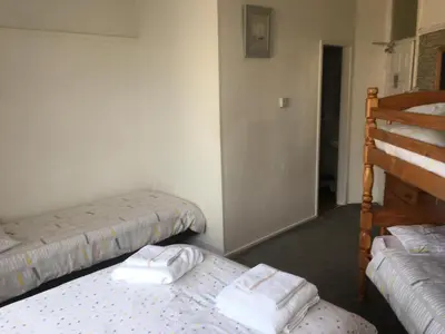 two beds in a room with towels on them at Royal Hotel in Blackpool