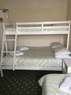 a bedroom with two bunk beds and a bed at Royal Hotel in Blackpool