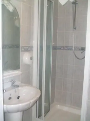 a bathroom with a sink and a shower at Royal Hotel in Blackpool