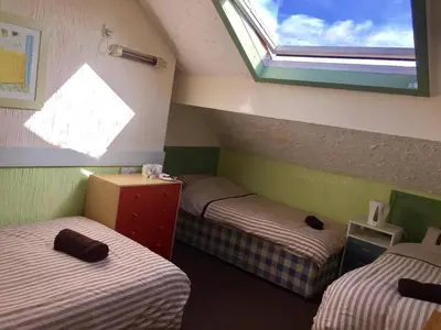 a room with two twin beds and a window at The Galloway in Blackpool