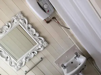 a bathroom with a mirror and a sink at The Galloway in Blackpool