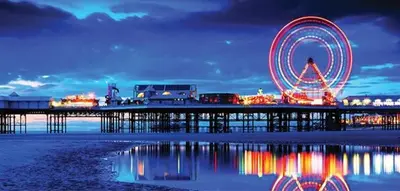 a ferris wheel on a pier at night at The Galloway in Blackpool