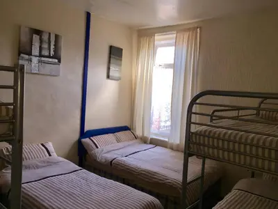 three bunk beds in a room with a window at The Galloway in Blackpool