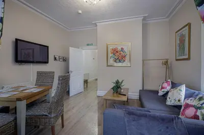 a living room with a couch and a table at Hornby Apartments in Blackpool