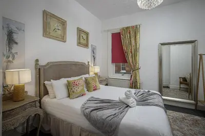 a bedroom with a bed with a stuffed animal on it at Hornby Apartments in Blackpool