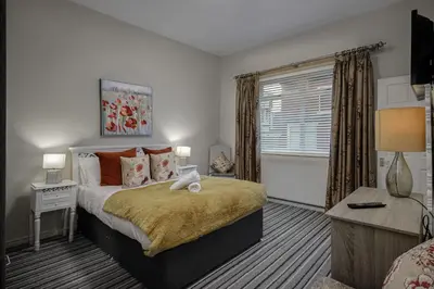 a bedroom with a large bed and a window at Hornby Apartments in Blackpool