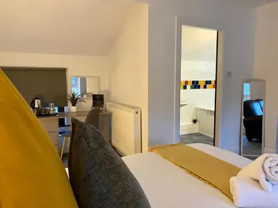 a bedroom with a bed and a living room at Crows Hotel in Lancaster