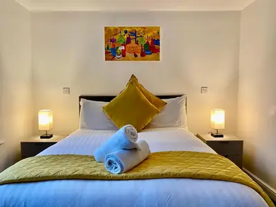 a bedroom with a bed with towels on it at Crows Hotel in Lancaster