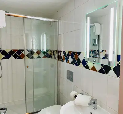 a bathroom with a shower and a sink at Crows Hotel in Lancaster