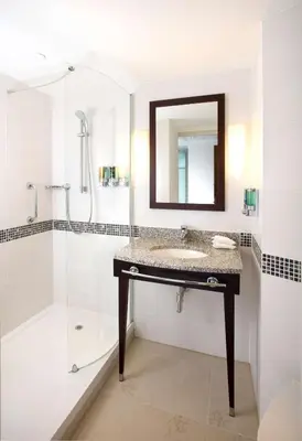 a bathroom with a sink and a shower at Hampton By Hilton Liverpool City Centre in Liverpool