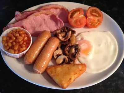 a plate of food with eggs sausage beans and bacon at Windsor Park Hotel in Blackpool
