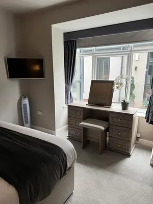 a bedroom with a bed and a desk with a laptop at Beach House Apartment on ground floor with sea view - pet friendly in Cleveleys