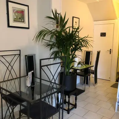 a dining room with a glass table and a plant at ParkRoyal Blackpool in Blackpool