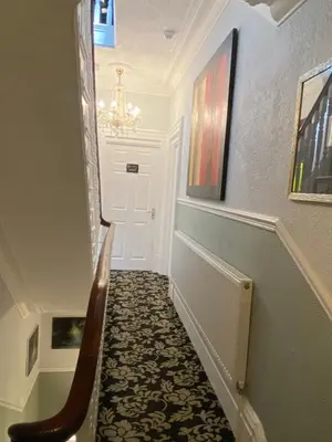 a hallway with a staircase with a chandelier at ParkRoyal Blackpool in Blackpool