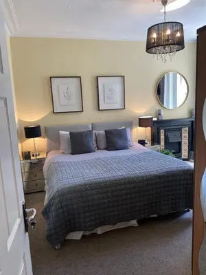 a bedroom with a bed and a chandelier at ParkRoyal Blackpool in Blackpool