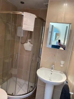 a bathroom with a shower and a sink and a mirror at ParkRoyal Blackpool in Blackpool