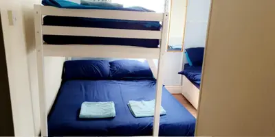 a bunk bed with two blue pillows on it at The Osprey Hotel in Blackpool
