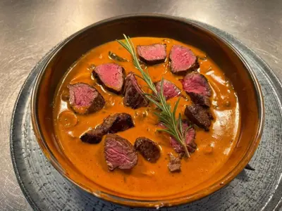 a bowl of soup with pieces of meat in it at The Royal Station Hotel in Carnforth