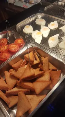 a tray of food with chips and eggs and tomatoes at Queens Plaza Hotel in Blackpool
