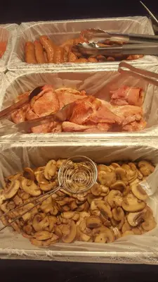 three trays of food with chicken and mushrooms in them at Queens Plaza Hotel in Blackpool