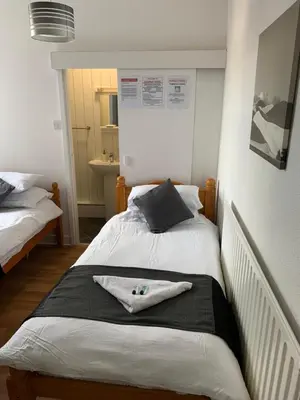 a bedroom with a bed with a towel on it at Alderley Hotel Blackpool in Blackpool